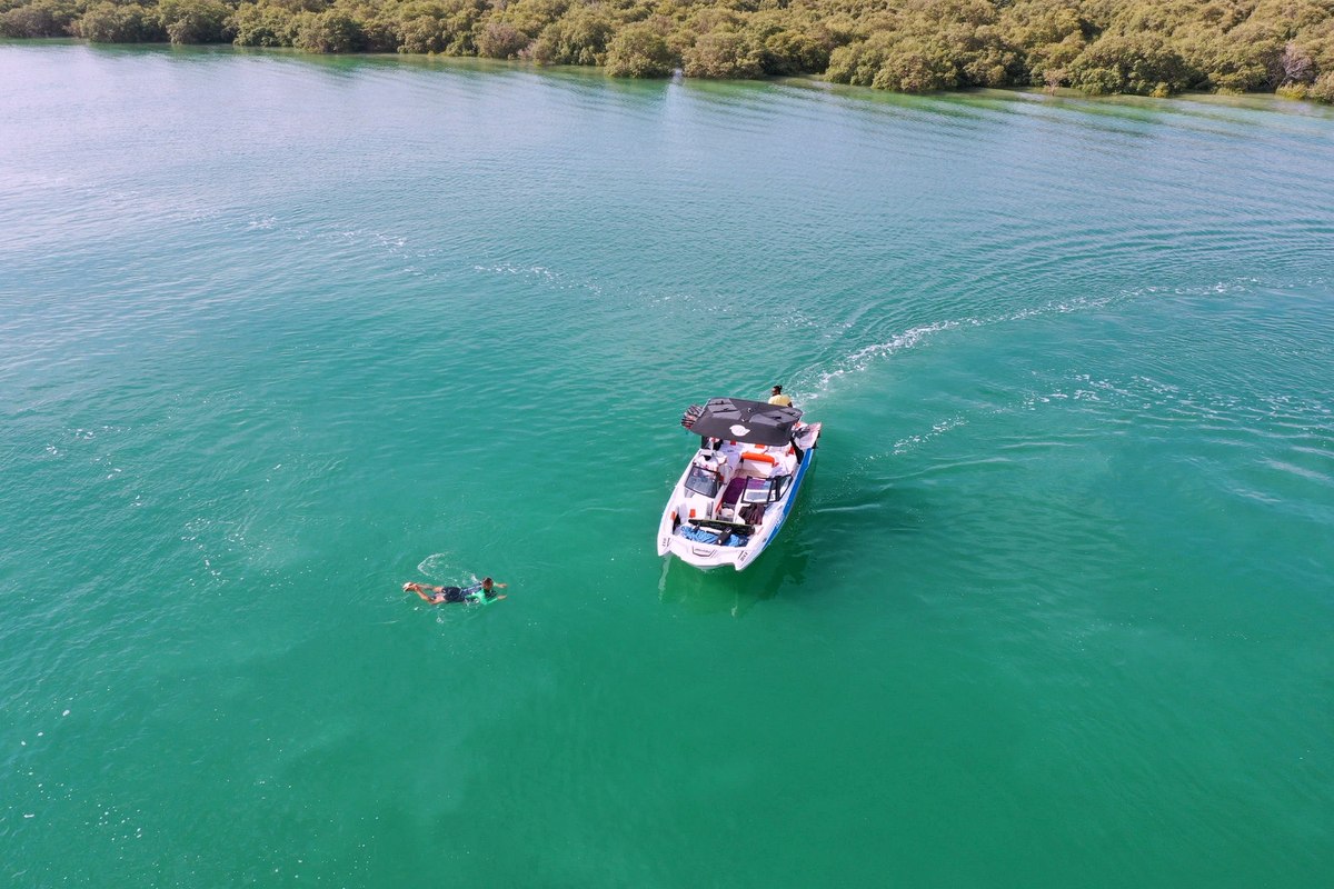 Eywoa Malibu 24 MXZ wake boat on turquoise mangrove water near Yas Island Abu Dhabi