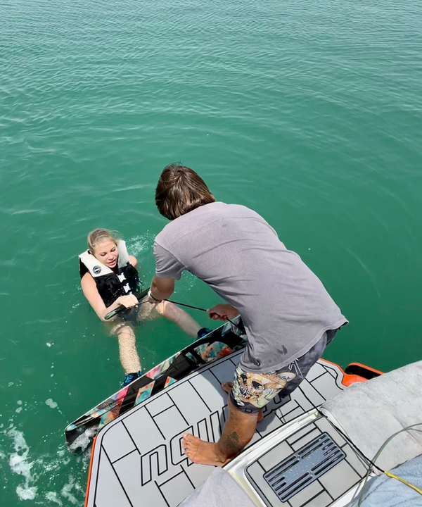Eywoa coach teaching a beginner to wakeboard near Yas Marina