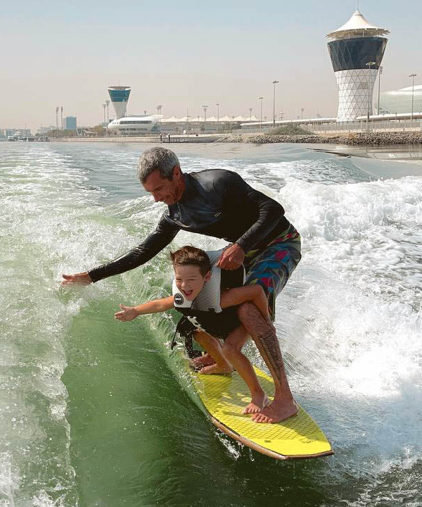 Eywoa coach teaching a child to wakesurf in Abu Dhabi
