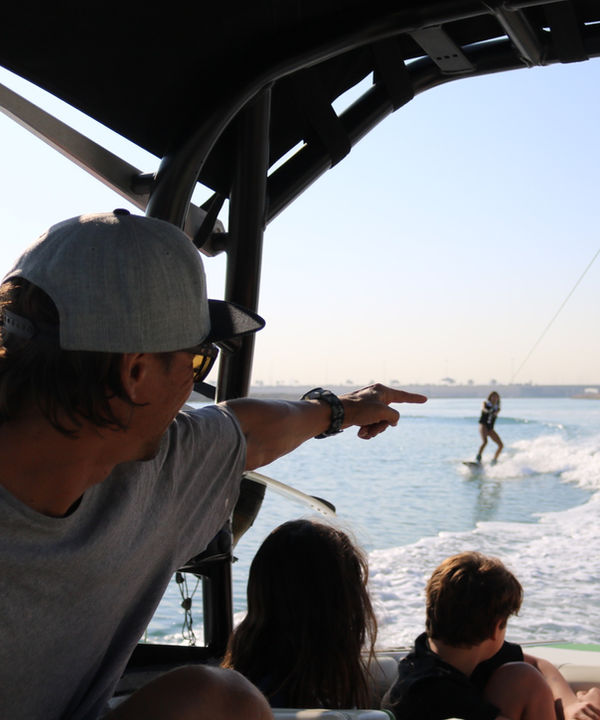 Eywoa coaching a child to wakeboard in Abu Dhabi
