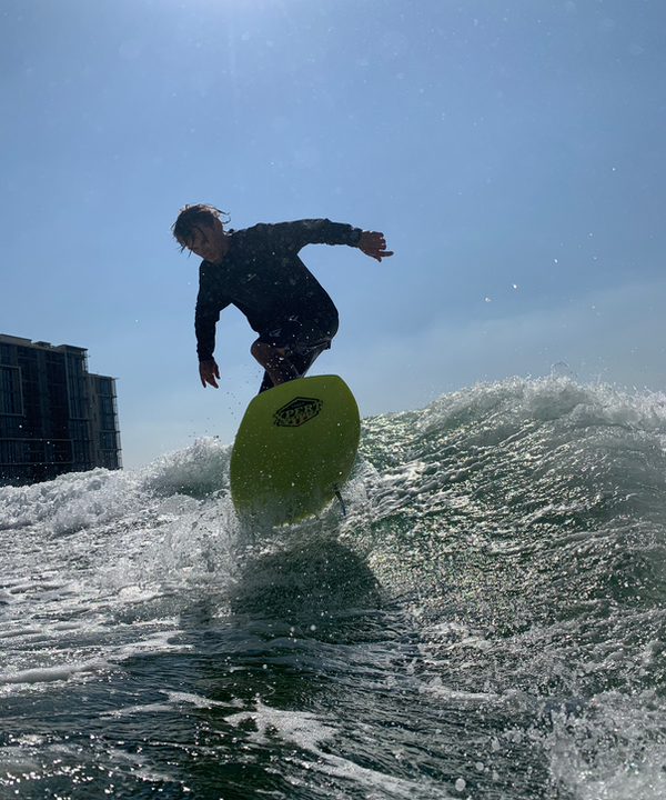 Eywoa coaches an air on the wakesurf near Yas Marina