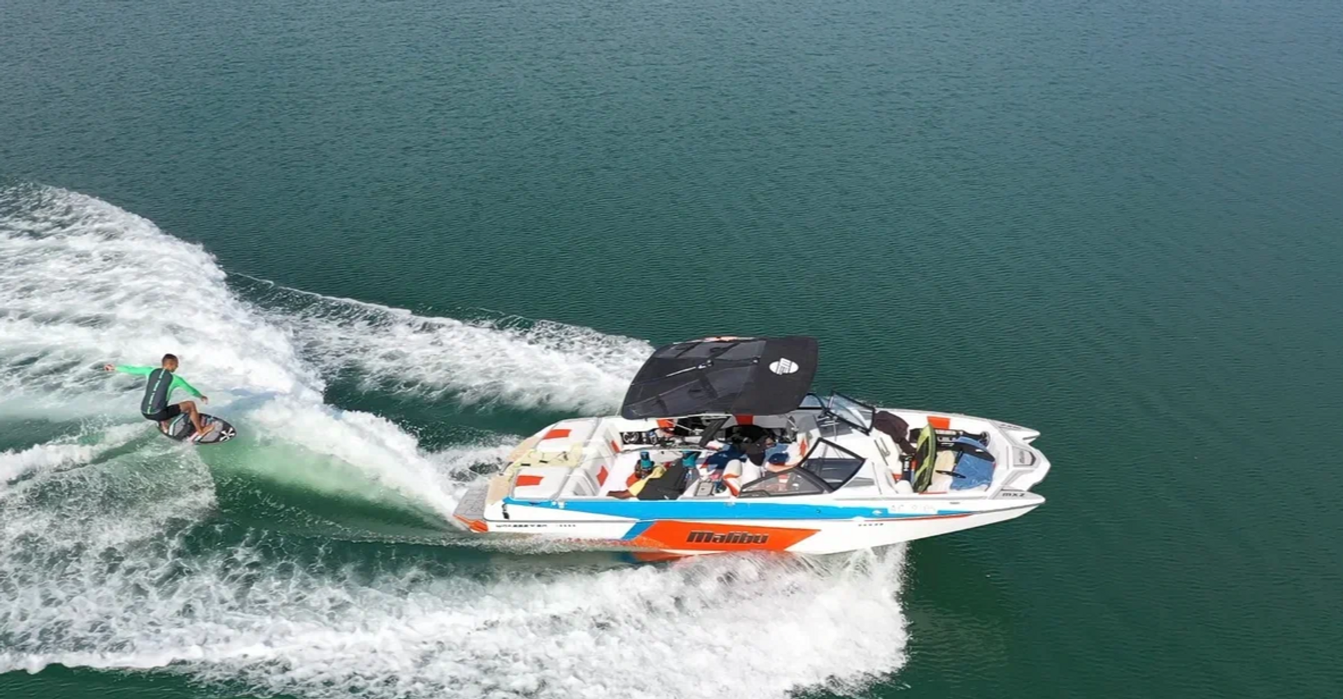 Rider surfing a clean wakesurf wave behind a Malibu boat near Yas Island, Abu Dhabi