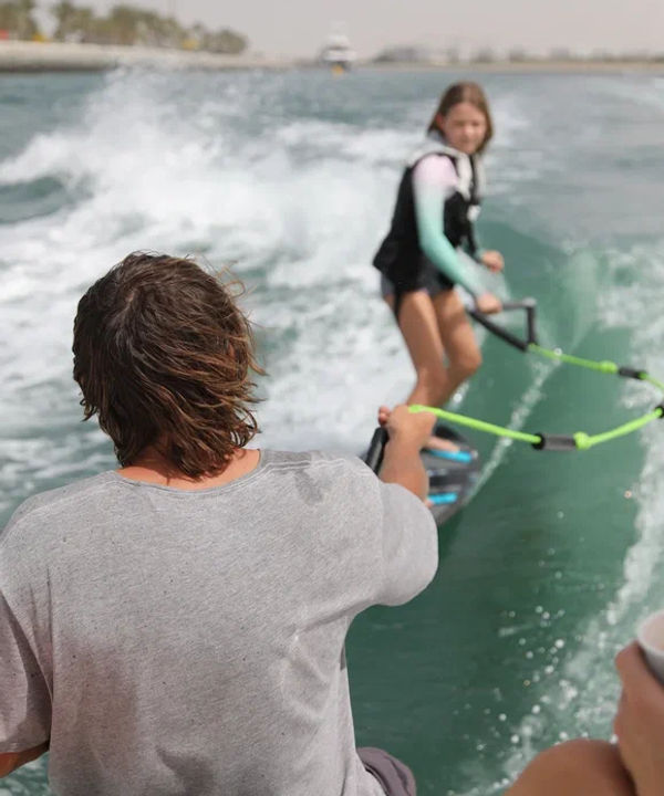 Eywoa coaching a child to wakesurf at Yas Marina Abu Dhabi