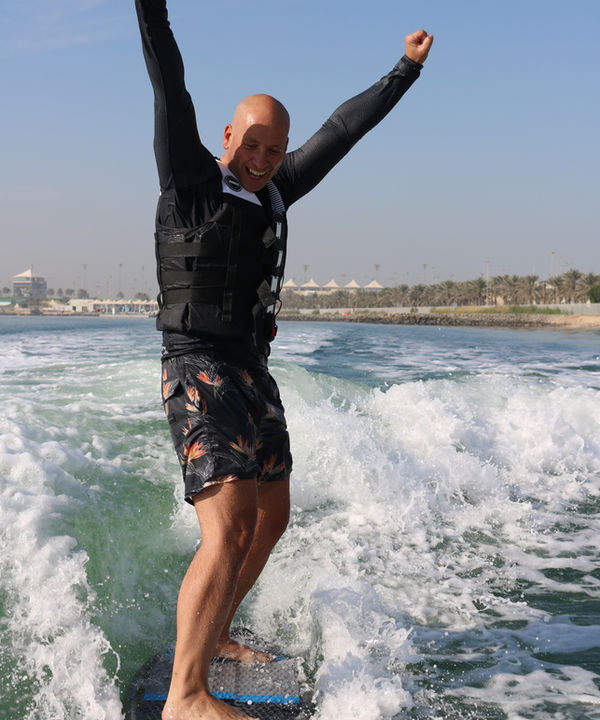 Rider celebrates a first switch wakesurf ride