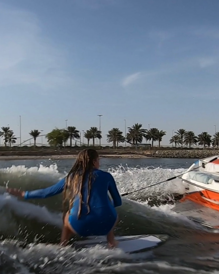 Eywoa rider surfing a massive wakesurf wave behind the Malibu 24 MXZ near Yas Marina